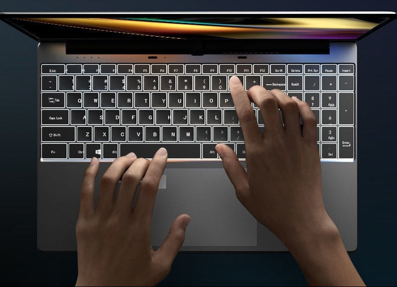 White backlit keyboard laptop Intel Core i7 – hands typing at night.