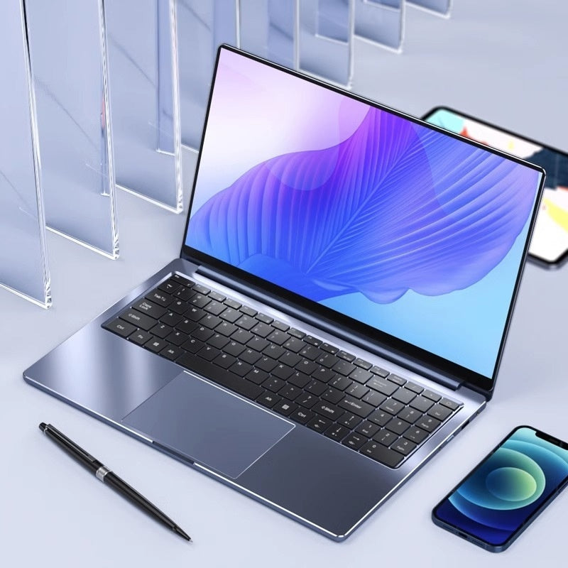 Silver laptop Intel Core i7 13th Gen on desk with smartphone – thin and lightweight design.

