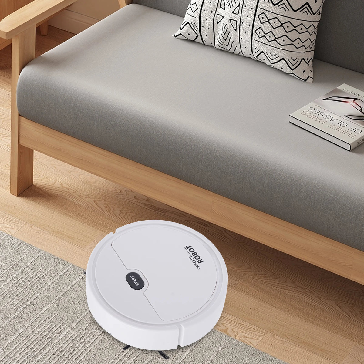 KT205 low-profile robot vacuum cleaner cleaning under a sofa.
