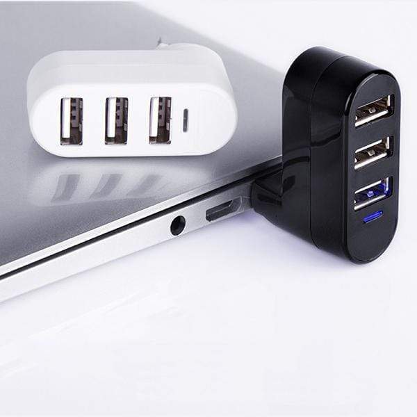 Black and white USB hub splitter connected to laptop - 3 port USB 2.0 multiport adapter.
